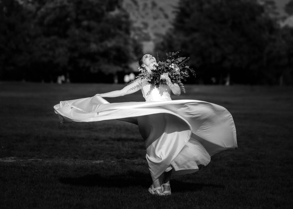 black and white portrait of a bride twirling her dress