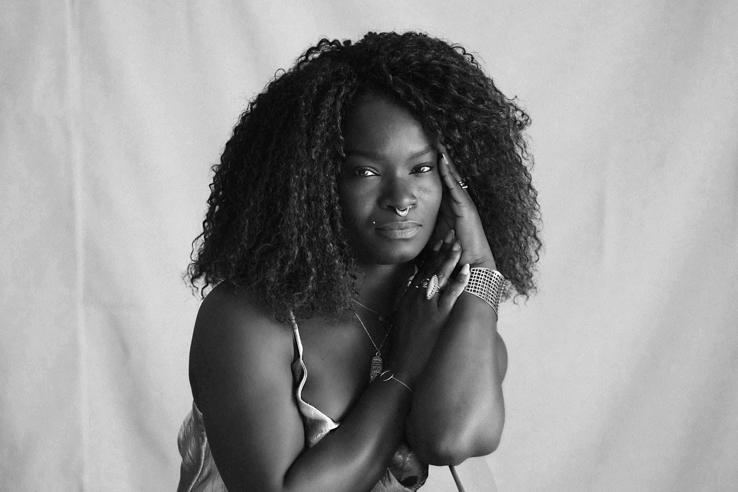 black and white editorial portrait of a black woman in a photo studio