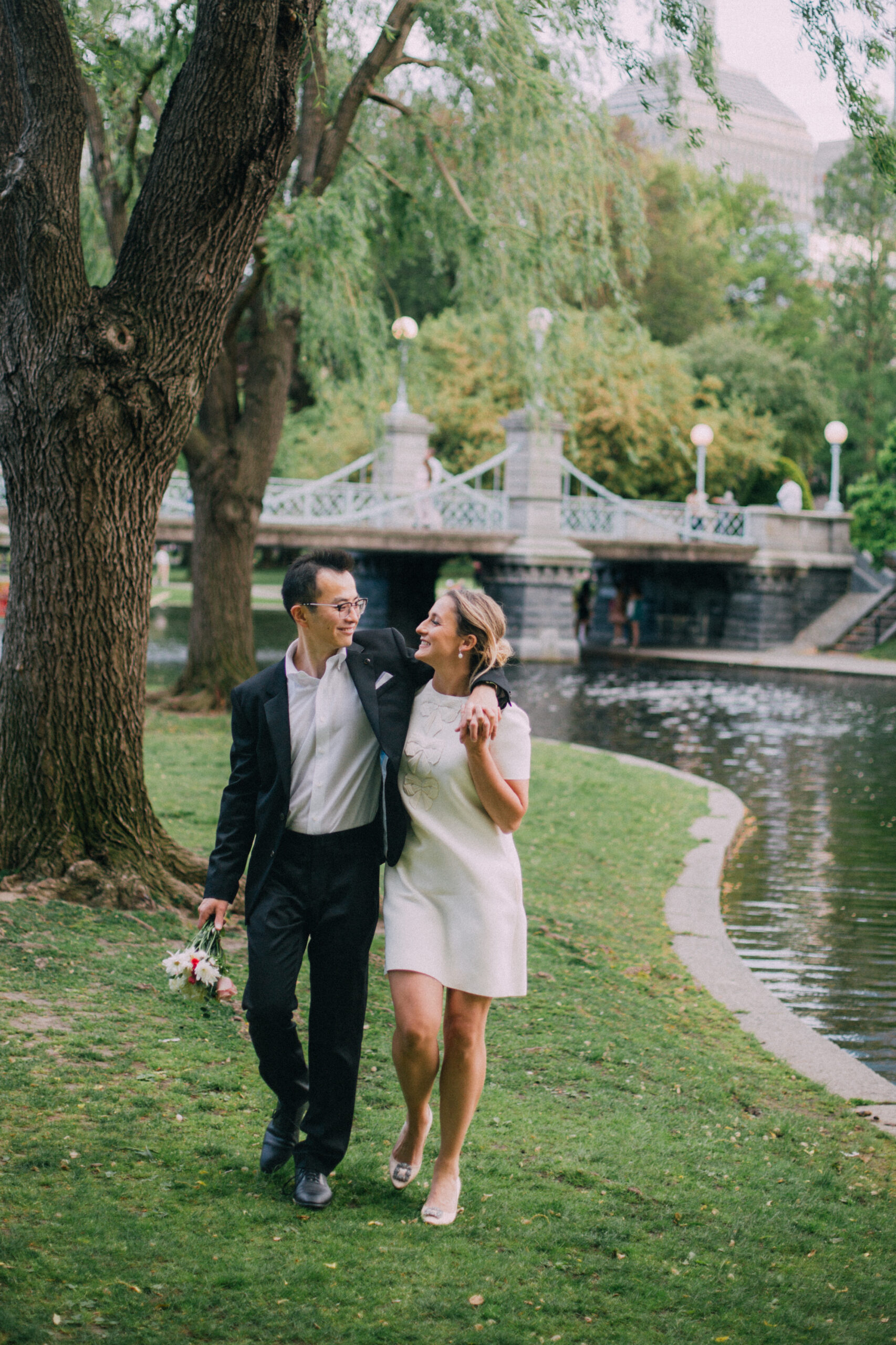 engagement photo of couple walking in boston public garden in the spring