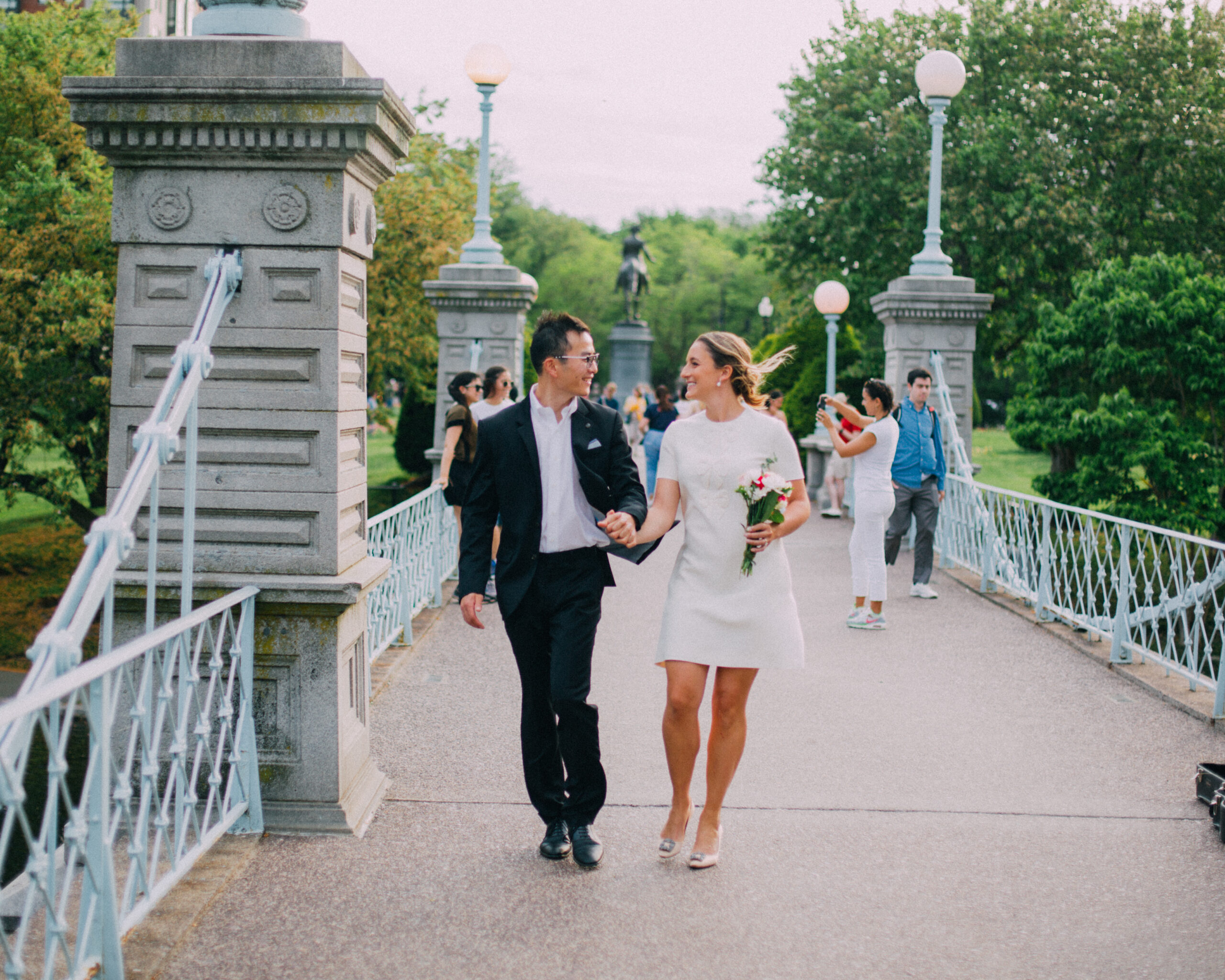 engagement photo of a couple on the bridge in the boston public garden