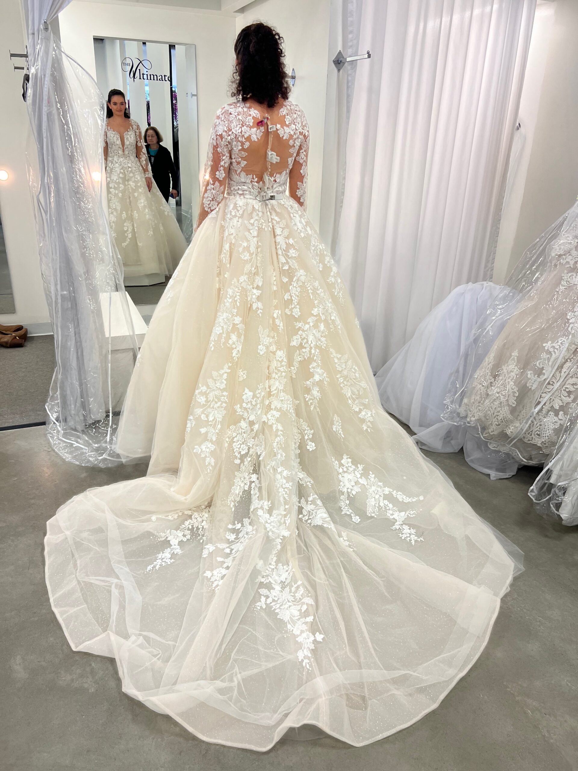 photo of a bride trying on a wedding dress at ultimate prom and bridal in peabody, ma