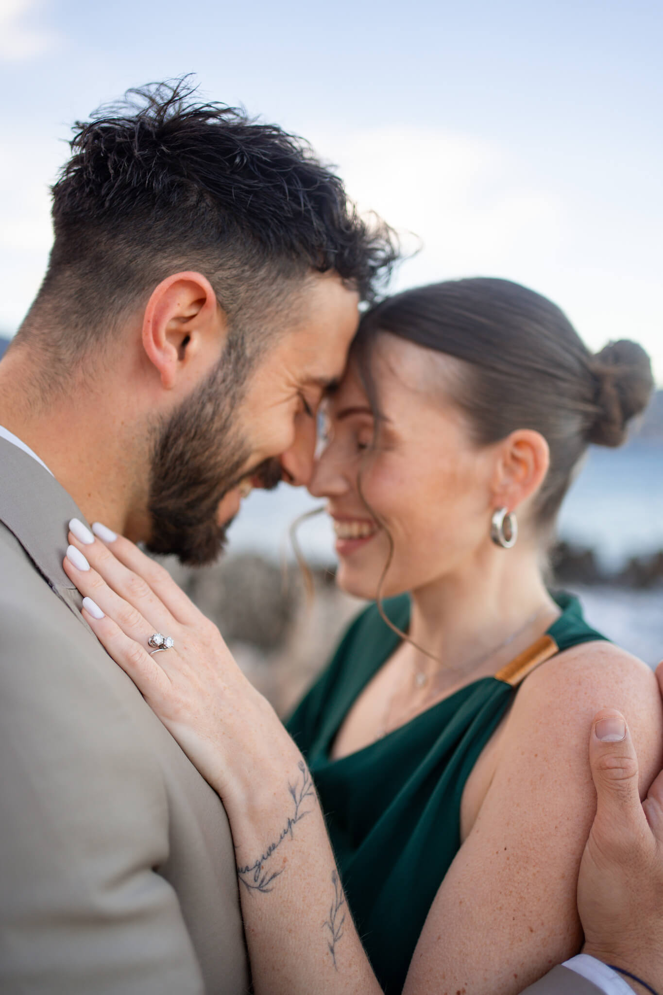 A happy couple dance touching foreheads in green and tan during their French Riviera Proposal