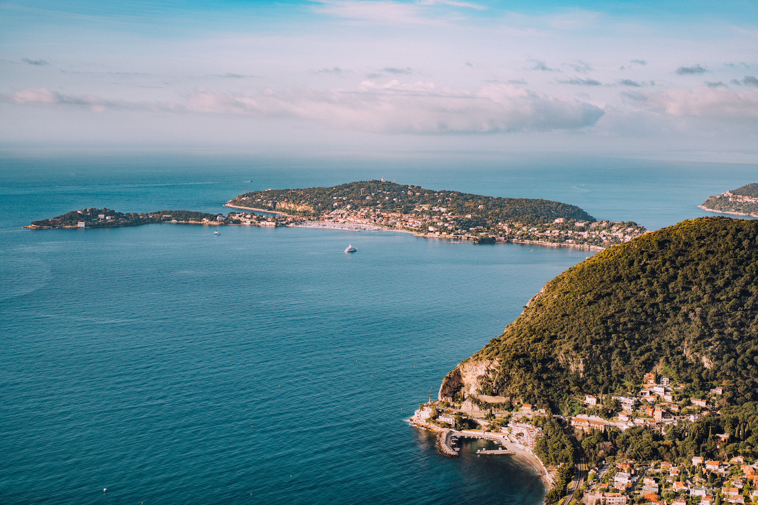 the view from the maybourne riviera hotel overlooks the coastline of the french riviera and the mediterranean sea.